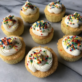 Frosting and sprinkles on Pinata Cupcakes