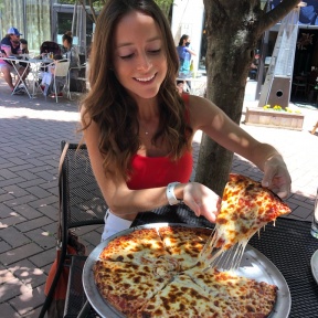 Jackie eating gluten-free pizza at Colony Pizza