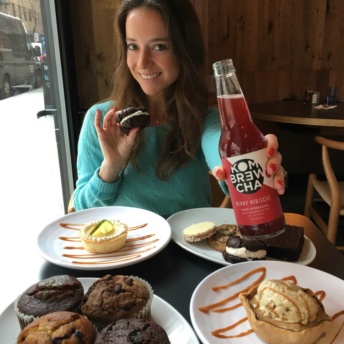 Jackie eating dessert at Tali and drinking Kombrewcha