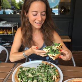 Jackie eating gluten-free pizza from Brick + Wood