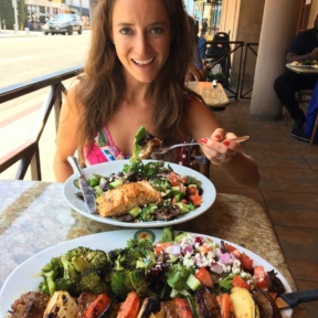 Jackie eating a salmon salad from Panini Kabob Grill