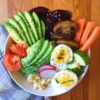 Bowl of veggies, eggs, and sesame seeds