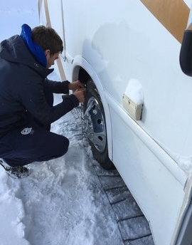 Brendan putting our snow chains on in Lake Tahoe