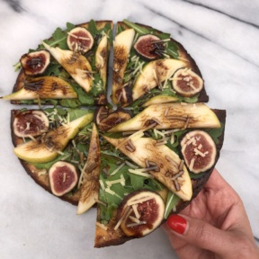 A slice of gluten-free KBosh Food zucchini pizza crust with pears, figs, and balsamic