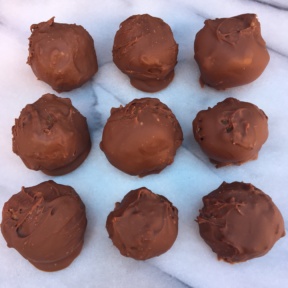 Nine gluten-free Chocolate Covered Peanut Butter Balls