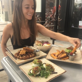 Jackie eating sweet potato fries at Primal Kitchen