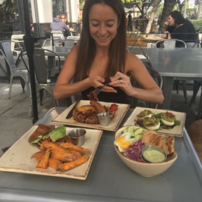 Jackie eating a gluten-free waffle at Primal Kitchen