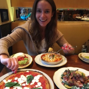 Jackie eating gluten-free pizza from Nizza