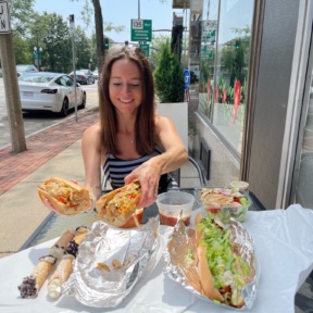 Jackie eating the chicken Philly sub from Lola's Italian Kitchen