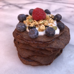 Stack of Three Ingredient Chocolate Pancakes with berries and yogurt