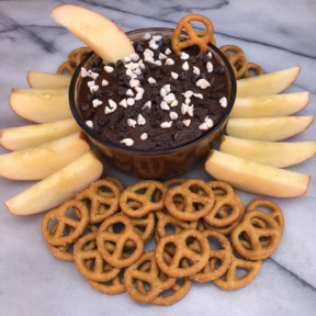 Dipping pretzels and apples in Brownie Batter Dip