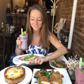 Jackie eating cheese bread at Senza Gluten Cafe & Bakery