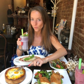 Jackie eating cheese bread from Senza Gluten Cafe & Bakery