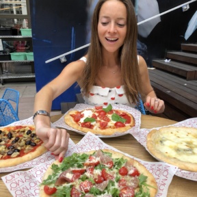Jackie eating gluten-free pizza from Ribalta Mo