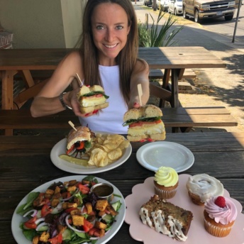 Jackie enjoying her bagel sandwich at New Cascadia