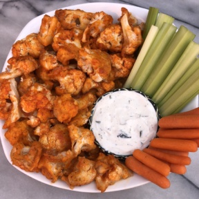 Cauliflower Buffalo Bites with celery and carrot sticks