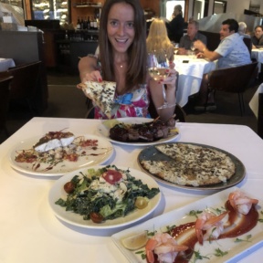 Jackie eating gluten-free pizza from Cafe del Rey