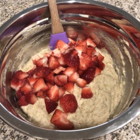 Fresh strawberries in batter for Strawberry Banana Protein Muffins