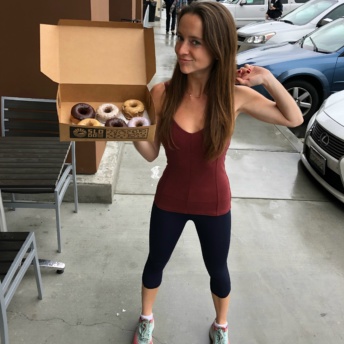 Jackie eating gluten-free donuts at SloDoCo