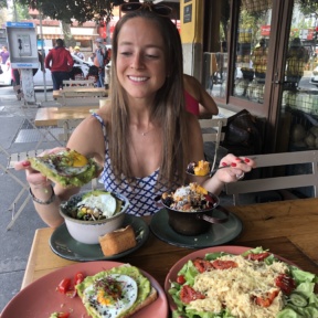 Jackie eating avocado toast at Ojo de Agua