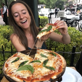 Jackie eating pizza at Rocco & Simona