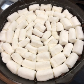 Adding marshmallows for S'mores Skillet Dip