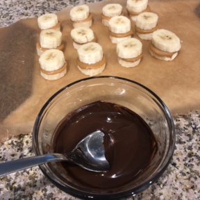 Making Banana Bites with melted chocolate