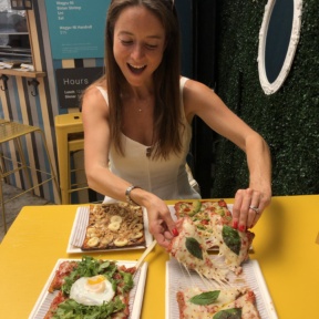 Jackie eating cauliflower pizza at Cheska's