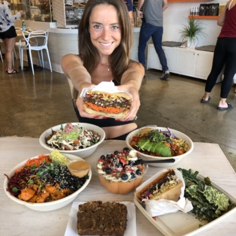 Jackie eating the burger at Vibe Organic Kitchen