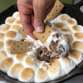 Brendan digging into Peanut Butter Cup S'mores Skillet Dip