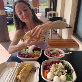 Jackie eating tacos at Papaya's Natural Foods