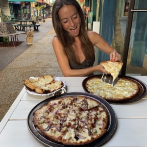 Jackie eating pizza at Hanalei Bay Pizzeria