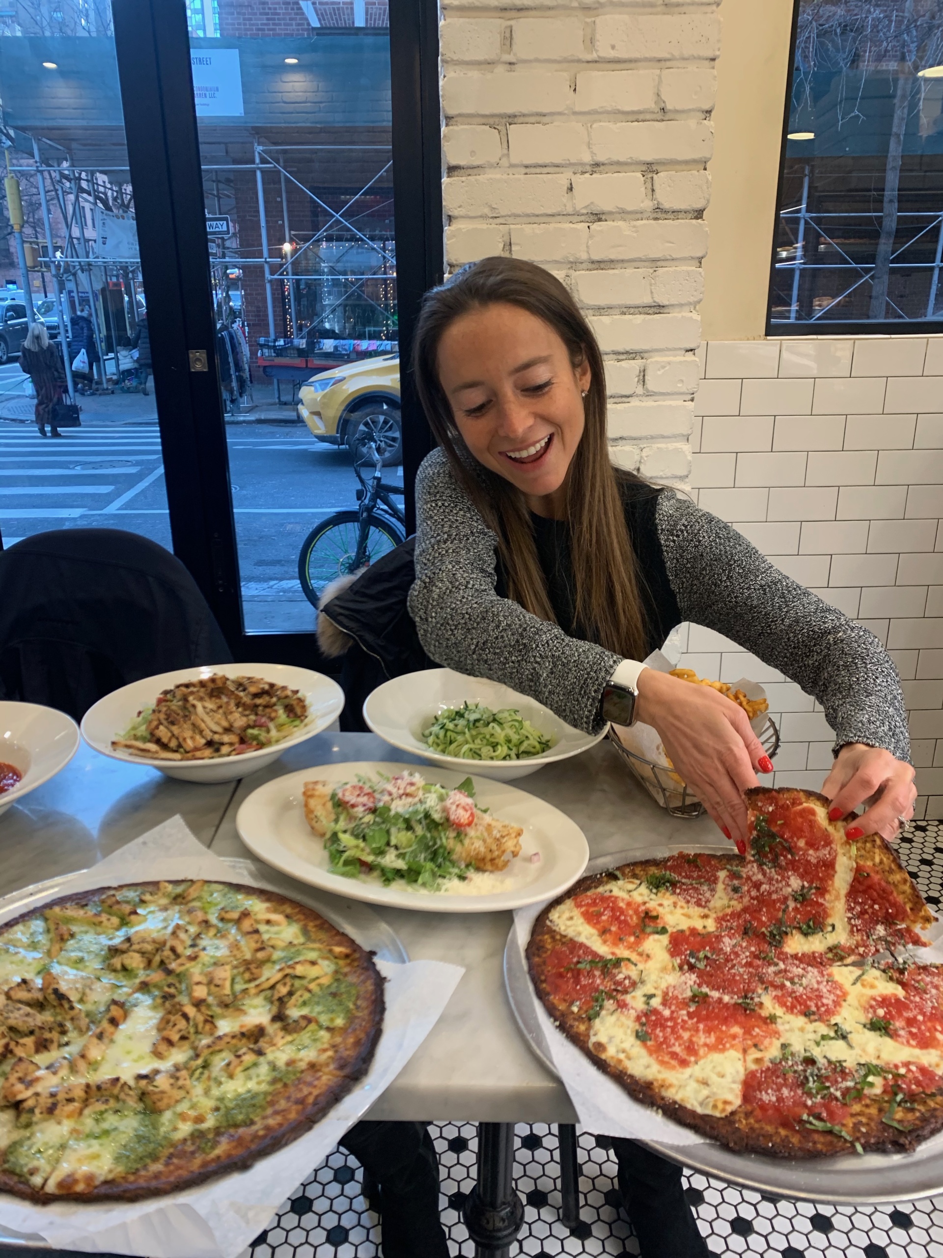 Jackie eating pizza at Marinara Pizza