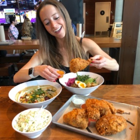 Jackie eating fried chicken at The Crack Shack