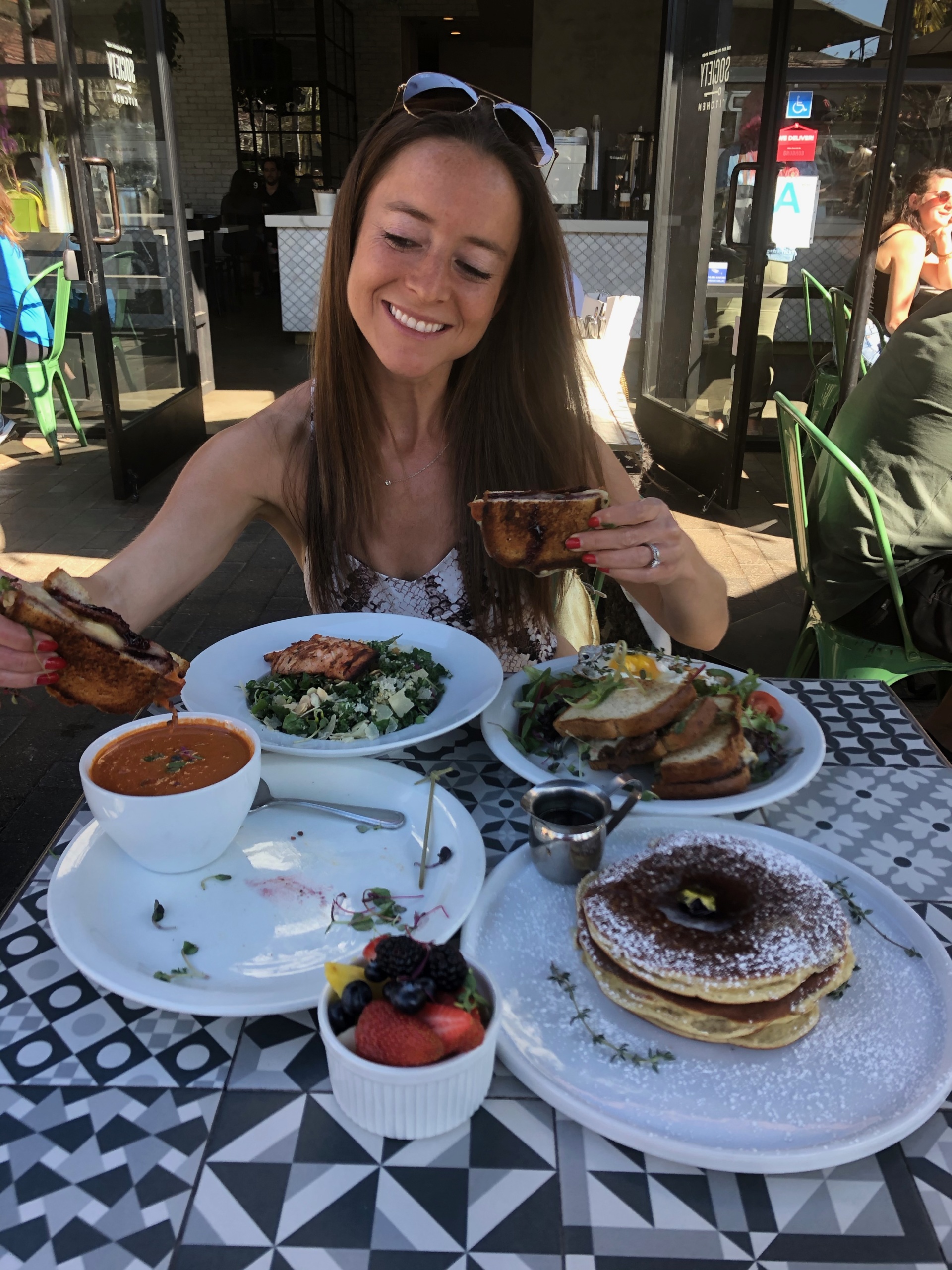 Jackie eating grilled cheese at Society Kitchen