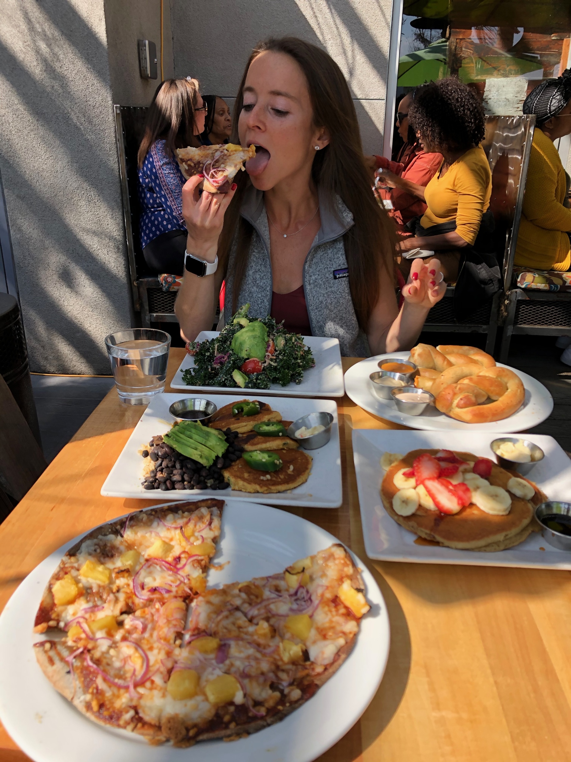 Jackie eating pizza at Sage Vegan Bistro