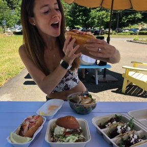 Jackie McEwan eating a lobster roll at Heibeck's Stand