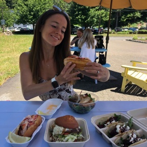 Jackie eating gluten-free lobster roll at Heibeck's Stand
