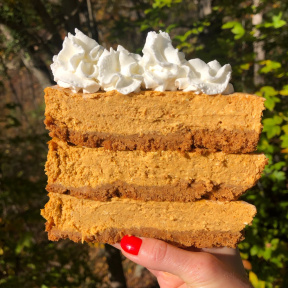 Stack of gluten-free Pumpkin Cheesecake with whipped cream