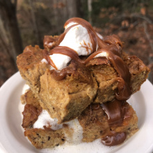 Pumpkin Bread Pudding with whipped topping and caramel sauce