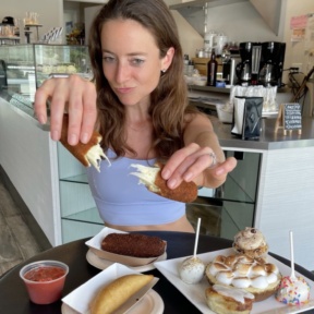 Jackie eating gluten-free mozzarella sticks at Dora's Bakery & Bistro