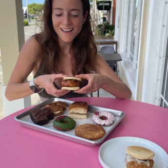 Jackie eating fried chicken at PAC Pastries