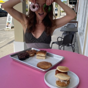 Jackie eating gluten-free vegan donuts at PAC Pastries