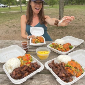Jackie eating chicken from Hawaiian Bros