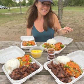 Jackie eating gluten-free chicken from Hawaiian Bros