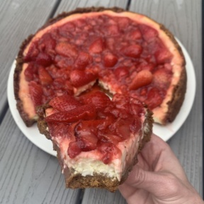 Big bite of gluten-free Strawberry Cheesecake