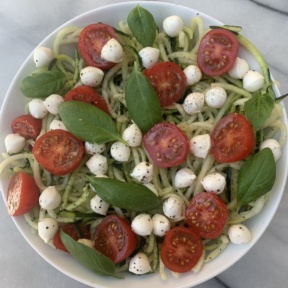 Gluten-free Caprese Zoodles with mozzarella, tomatoes, and basil