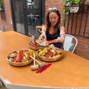 Jackie eating gluten-free seafood boil from SONO Boil