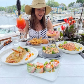 Jackie eating a lobster roll at The Boathouse
