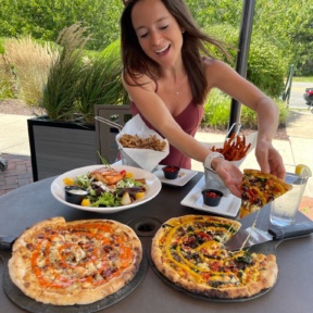 Jackie eating pizza at Wicked Restaurant